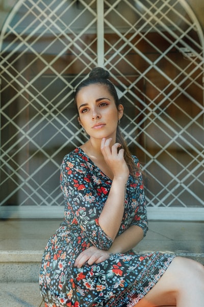 woman in white blue and red floral dress